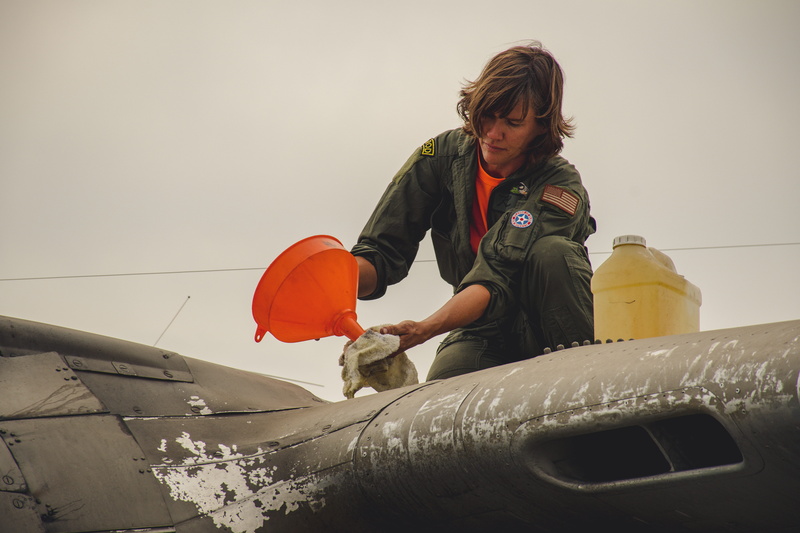 technology, safety, bottle, low angle view, adult, airplane crew, one person, airplane, recreation, outdoors, daylight, real people, transportation, protection