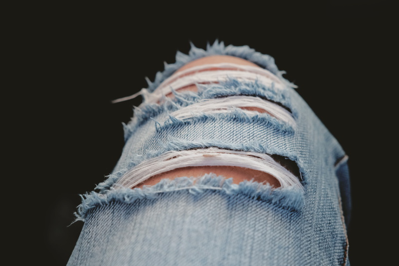 one animal, indoors, softness, 5K, bottoms, body part, black background, gray, denim, clothes, modern, ripped, casual clothing, textile, model, fashionable