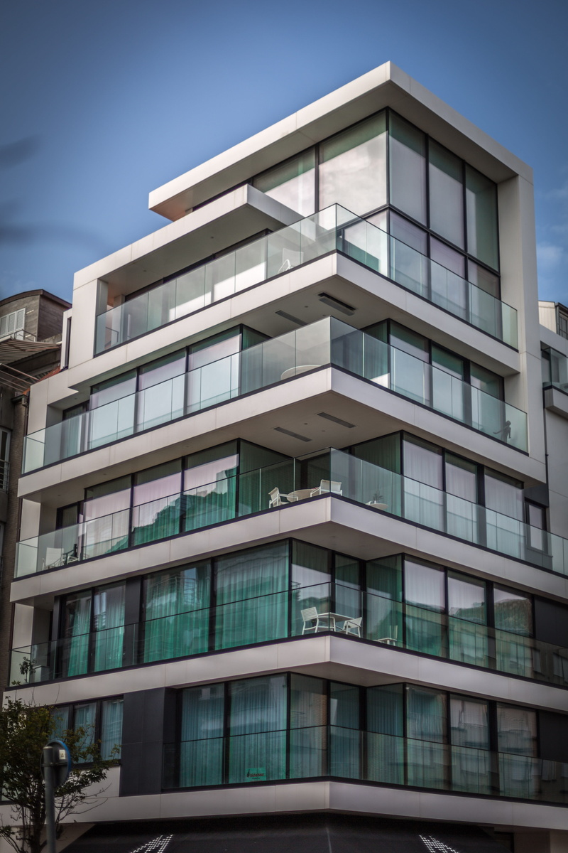 glass - material, urbanization, blue, day, pattern, outdoors, residential district, sky, no people, window, city, facade, building exterior, reflection