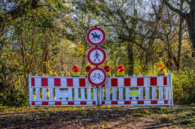 security, roadblock, road sign, shield, sign, road, tree, forest way, autumn, text, site, land, number, outdoors, symbol, communication, pedestrian, locked