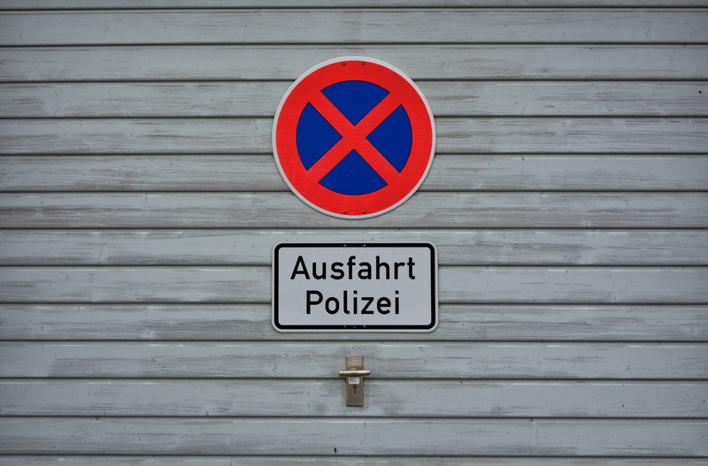 shield, no parking sign, information, sign, architecture, absolute parking, no people, communication, wood - material, built structure, symbol, traffic sign