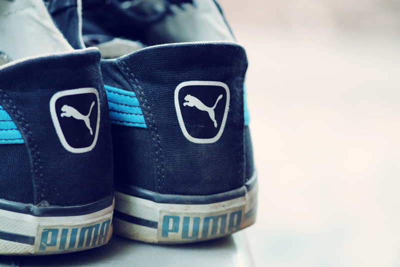 two objects, copy space, indoors, puma, black color, high angle view, vintage, number, pair, day, focus on foreground, table, shoe, still life, communication