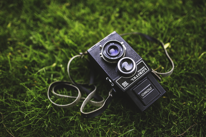 arts culture and entertainment, close-up, field, high angle view, technology, focus on foreground, no people, land, digital camera, grass, medium, vintage