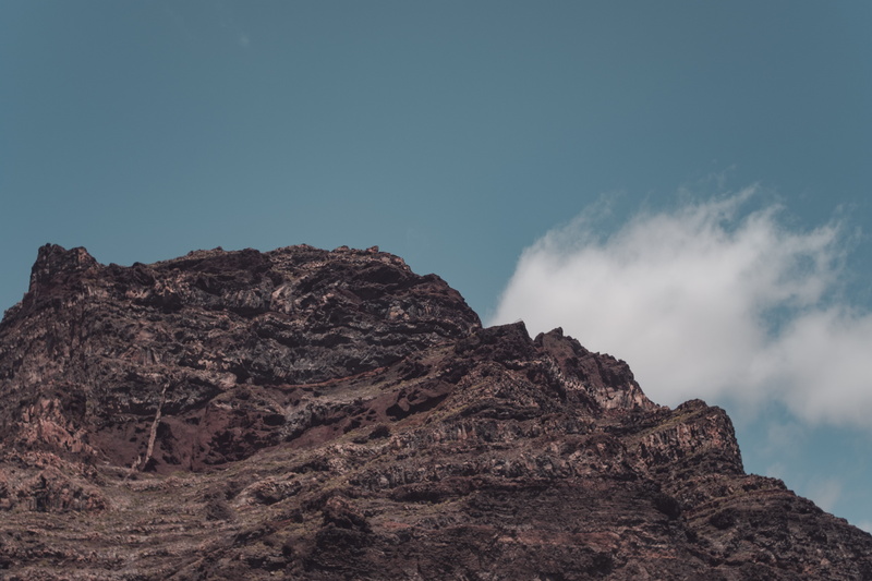 clouds, path, tranquil scene, outdoors, high, beauty in nature, eroded, 5K, rock - object, 28mm, rocks, vintage, blue, mountain peak, sky, arid climate