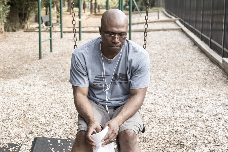 casual clothing, shirt, wearing, daytime, american, one Person, males, shaved head, depression, outdoors, adult, athlete, exercising, sports Clothing, swing