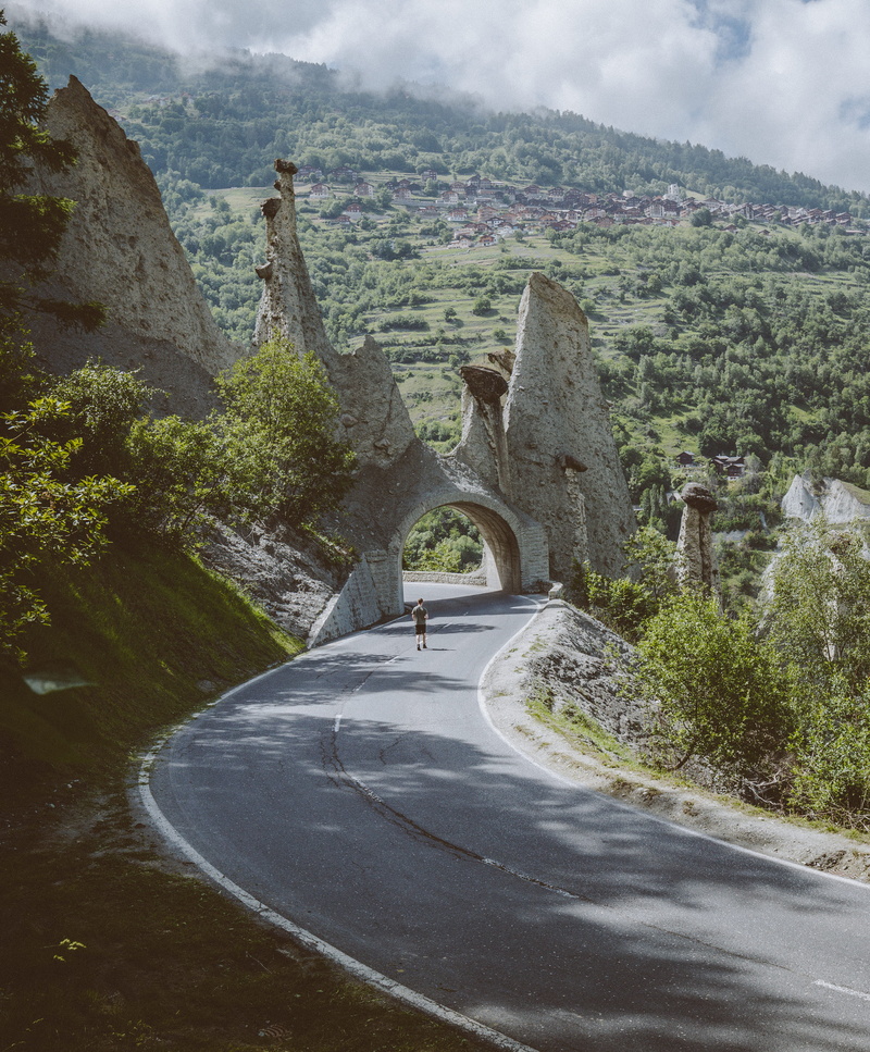 outdoors, tunnel, mountain, day, adventure, standing, guy, walking, road, plant, near, beauty in nature, no people, the way forward, nature, direction
