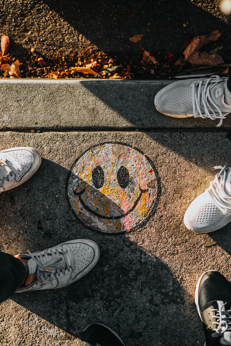 5K, human limb, real people, day, street, people, feet, standing, art, leisure activity, pavement, human leg, outdoors, smiley, concrete, front, one person