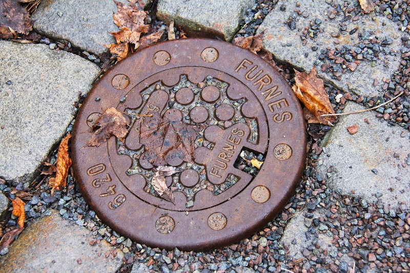 sewage, travel, geometric shape, ground, text, scandinavia, cold, old, rusty, coin, shape, souvenir, outdoors, pebble, europe, oslo, directly above, high angle view
