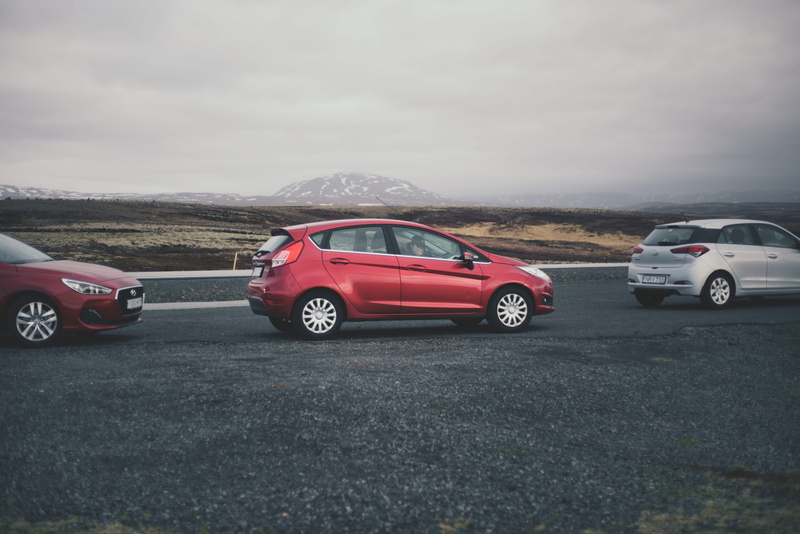 road, mode of transportation, wheel, waiting, human, red, no people, car placement, outdoors, travel, sign, car wheel, transportation, motor vehicle, asphalt