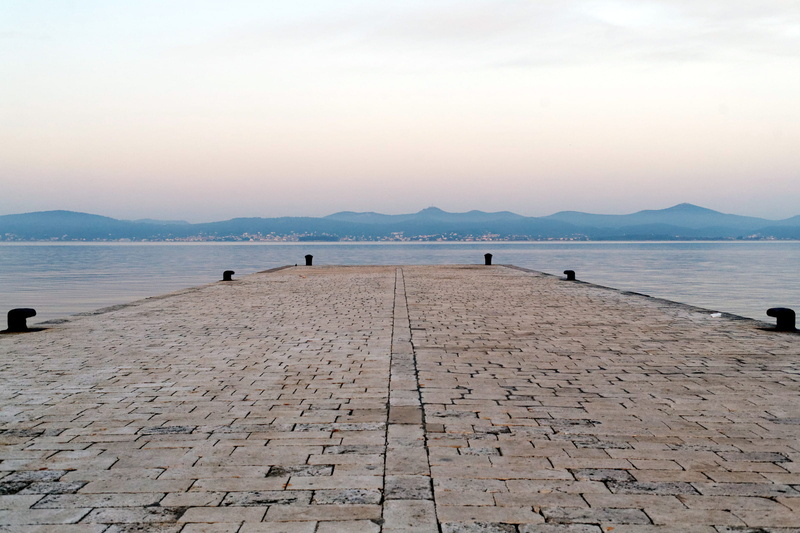 sky, tranquil, cloud - sky, pier, waterfront, sea, paving stone, the way forward, platform, tranquil scene, landing, peaceful. stark, outdoors, sunset