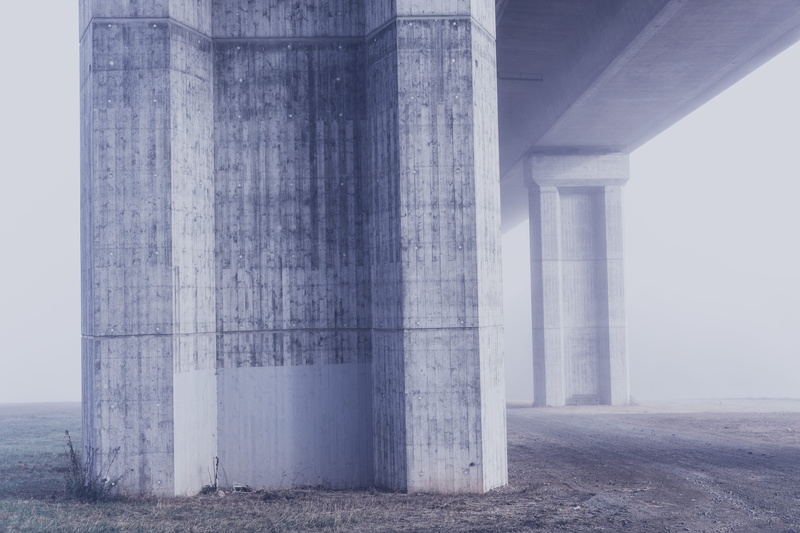 architectural column, concrete, bright, connection, buttress, high, no people, bridge - man made structure, underneath, business, road, strength, nature