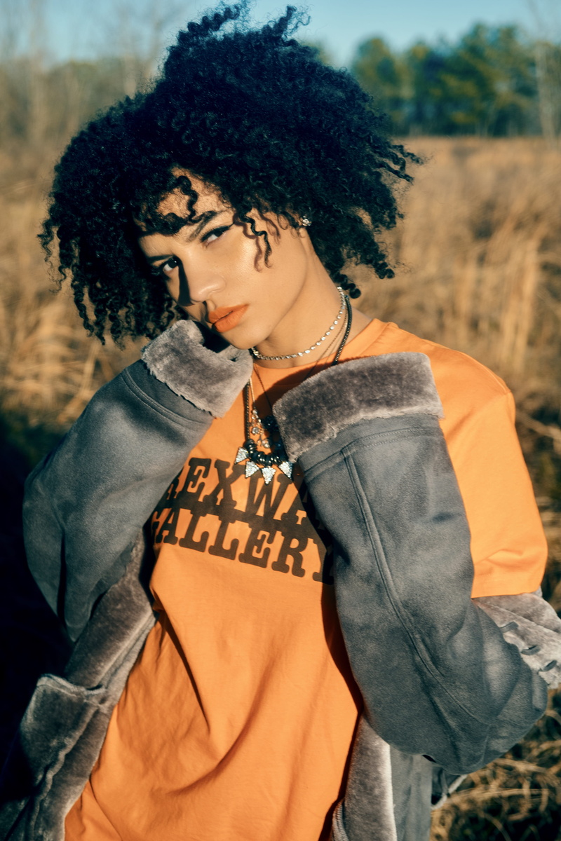 adult, portrait, curly hair, looking away, outdoors, contemplation, hair, fashion, united states, front view, clothing, casual clothing, waist up, beauty