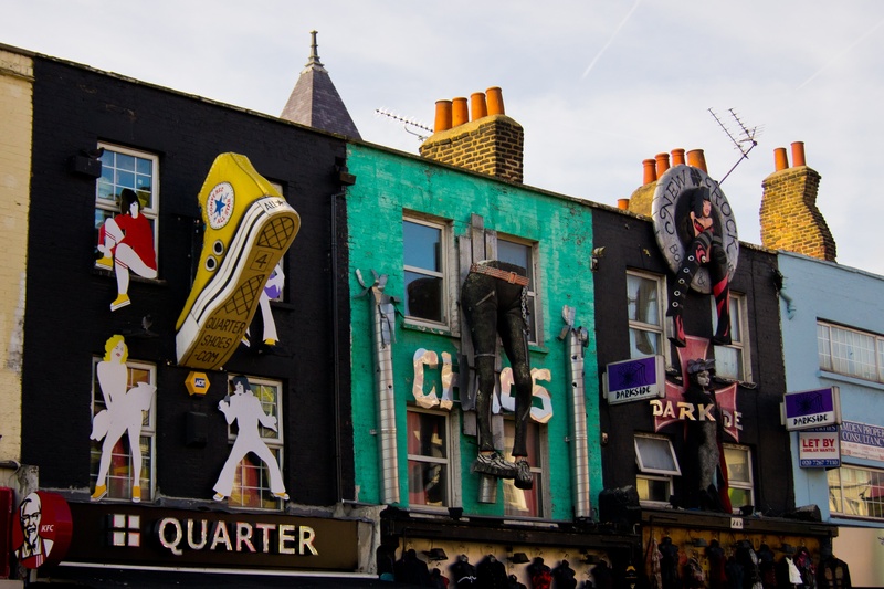 human representation, market, daytime, male likeness, sky, camden, built structure, sculpture, assorted, mural, day, art and craft, shops, colorful, low angle view
