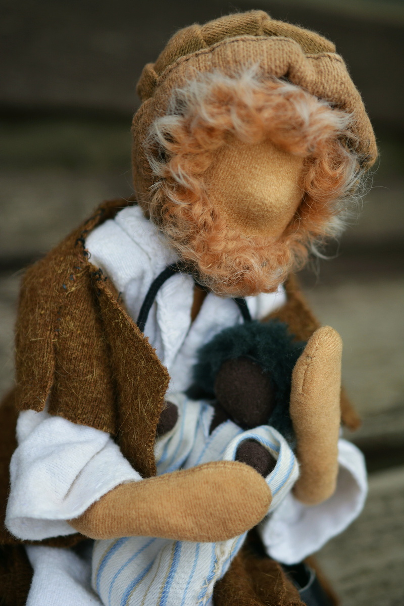 looking, figures, dolls, close-up, day, teddy bear, real people, hand labor, rag doll, figure, toy, warm clothing, adult, white hair, focus on foreground