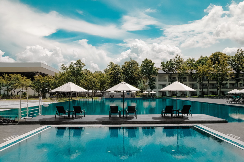 cloudy, reflection, swimming, poolside, architecture, villa, sky, hotel, swimming pool, outdoor, vacation, cloud - sky, tree, day, turquoise colored, leisure