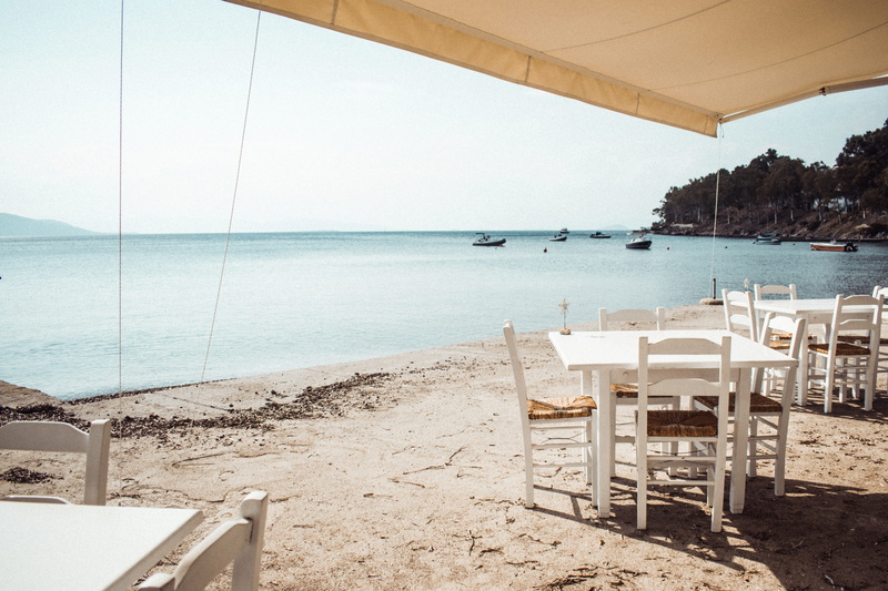 sky, aegina, sunlight, furniture, seat, wooden, ocean, outdoors, sea, two, hotel, sand, tables, chair, no people, dock, beach, beauty in nature, housing