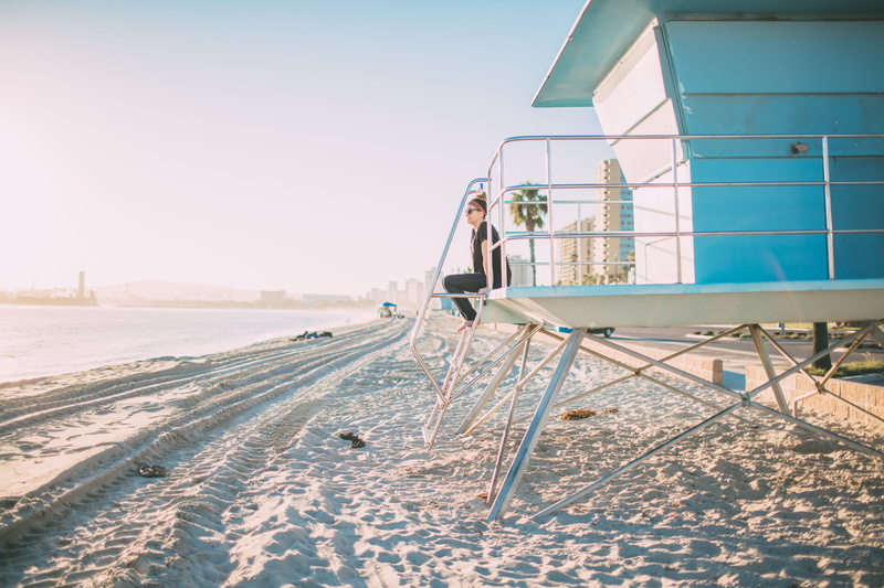 outdoors, built structure, warm, leisure activity, nature, sky, lifeguard post, copy space, hour, woman, luxury, beach, young adult, adult, sand, sunset