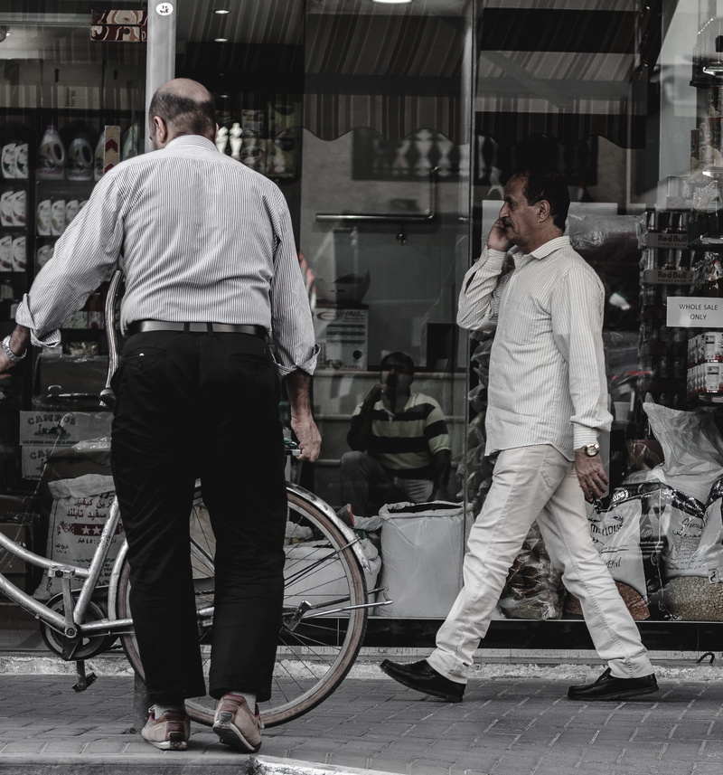 standing, incidental people, street photo, outdoors, rear view, real people, full length, occupation, men, casual clothing, lifestyle, cellphone, day, group of people