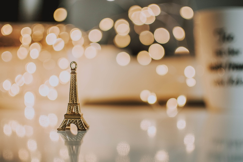 christmas lights, light, close-up, 5K, built structure, indoors, focus on foreground, defocused, figure, gold colored, eiffel, holiday, eiffel tower, shape