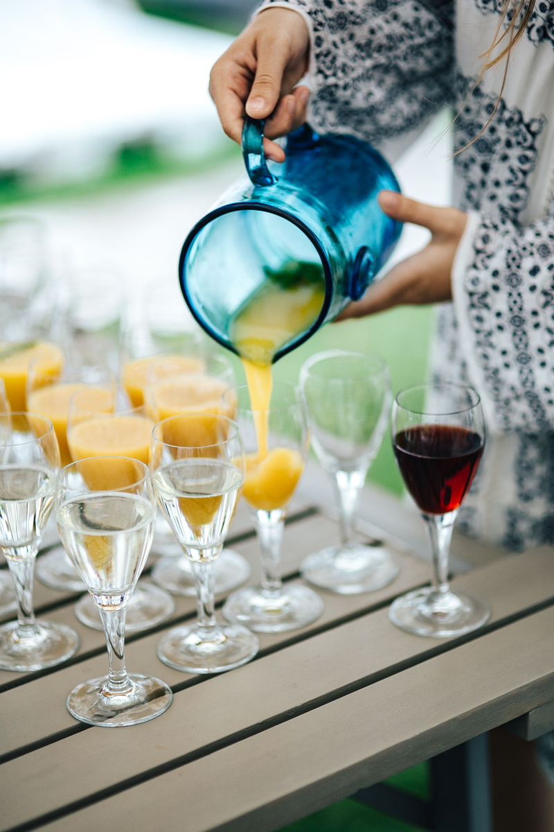 drinking glass, glass - material, orange, martini, cocktail, food and drink, wine, focus on foreground, drink, wineglass, human body part, pouring, water