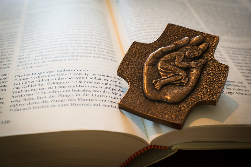 text, ornament, education, redemption, healing, brown, book, religion, western script, metal, cross, page, god, close-up, bible, indoors, bronze, still life