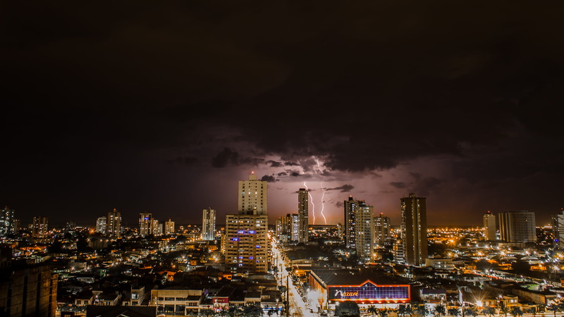 built structure, skyline, clouds, citylights, skyscraper, urban, time, thunderstorms, outdoors, tall - high, urban skyline, sky, office building exterior