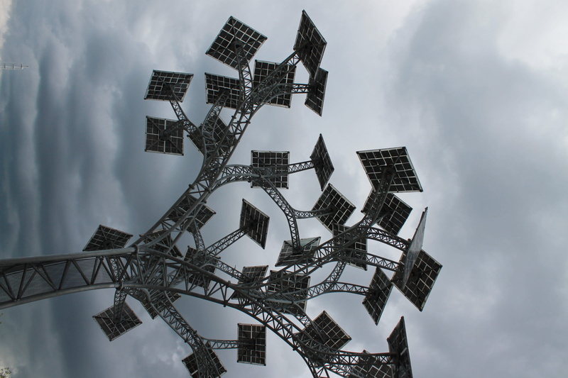 building exterior, tall - high, outdoors, cloud - sky, cloudy, tree, city, built structure, day, 4K, no people, financial district, solar energy, architecture