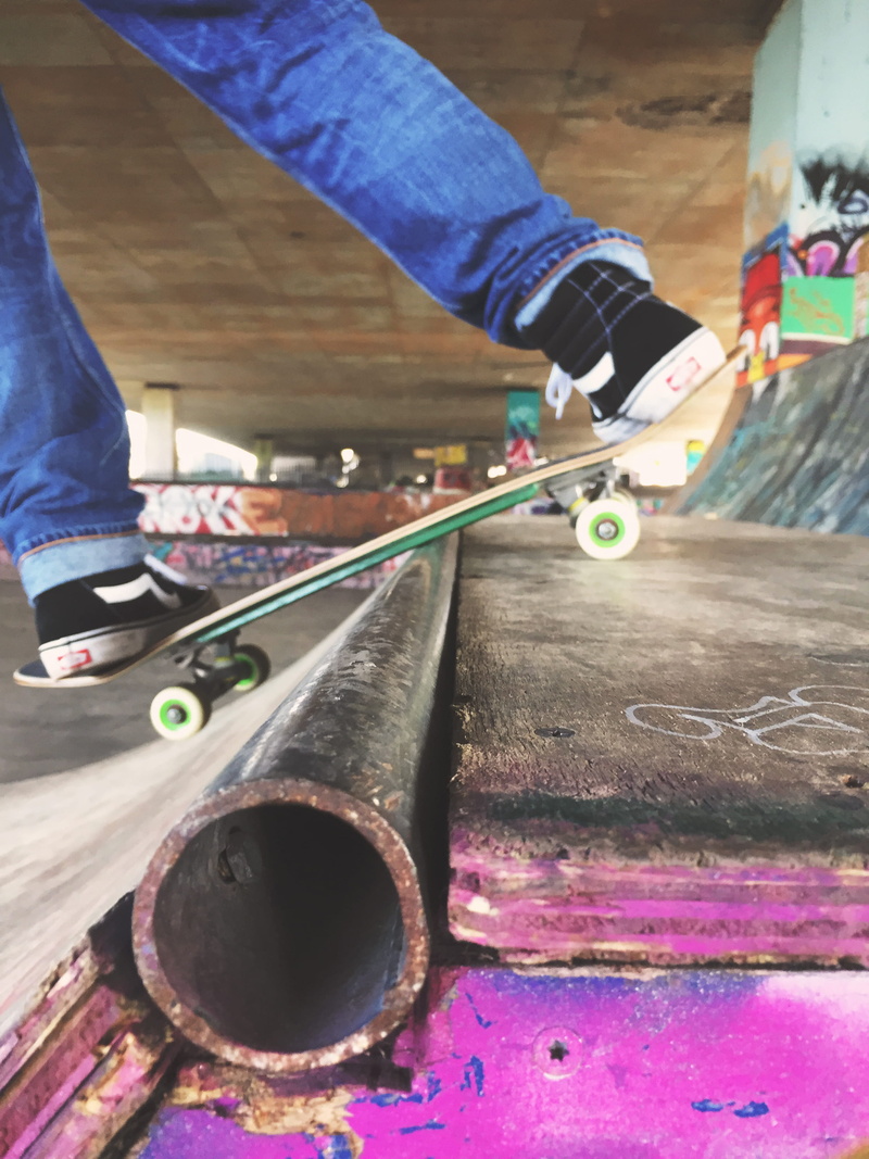 human limb, skill, skateboard, motion, city, man, sneakers, real people, day, human body part, skatepark, high angle view, wood - material, hand, lifestyles
