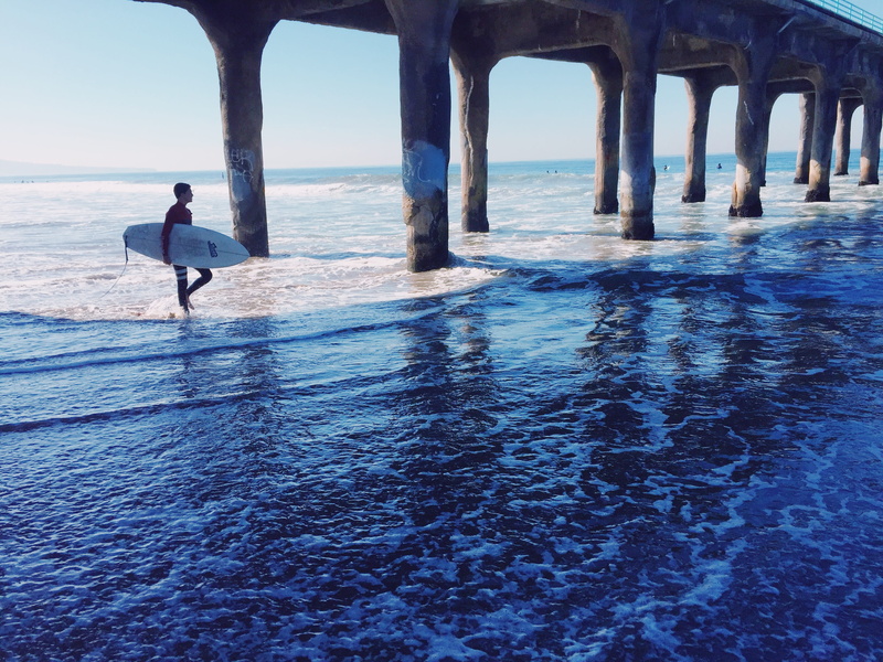 real people, carrying, beauty in nature, sea, one person, land, blue, sand, dock, manhattan beach, person, sports, beach, full length, sky, ocean, horizon over water