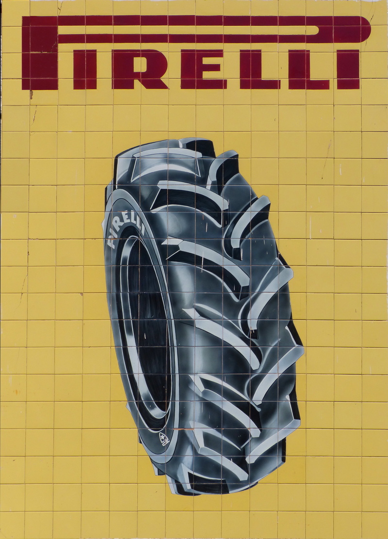 black color, tires, vintage, tile, wheel, flooring, mural, built structure, day, close-up, yellow, no people, design, advertising, shape, pirelli, geometric shape