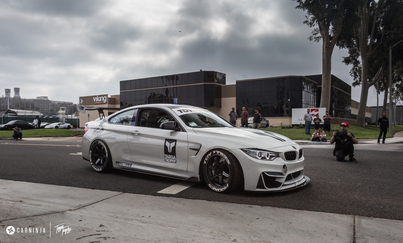 city, incidental people, overcast, transportation, tree, architecture, nature, Carninja, low, car, street, built structure, text, road, motor vehicle, cloud - sky