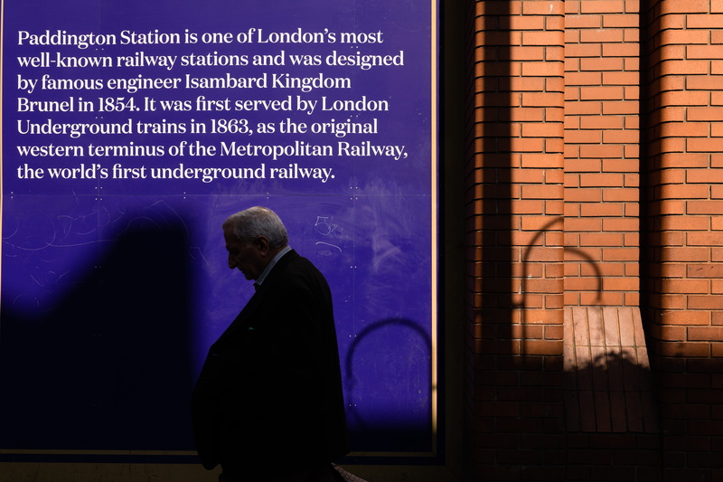 station, adult, built structure, standing, rear view, united kingdom, urban, london, communication, uk, western script, 5K, wall - building feature, outdoors