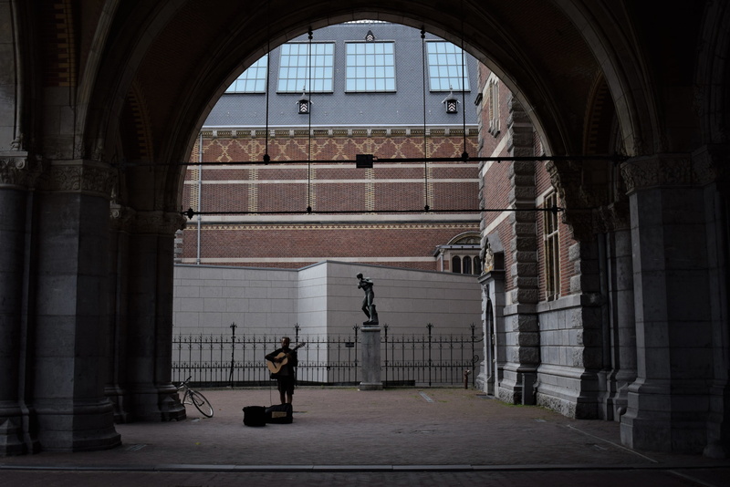 building exterior, musician, dark, monument, the past, column, leisure activity, full length, men, real people, silhouette, music, history, adult, building