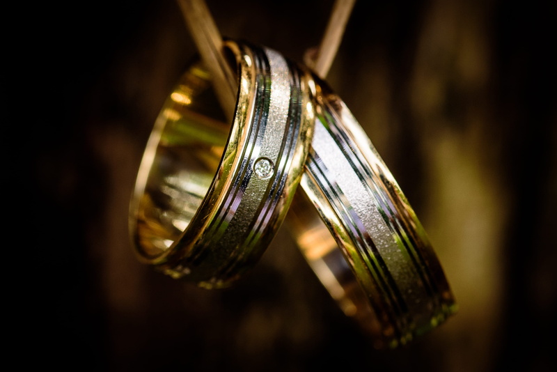 no people, close-up, focus on foreground, 2K, wedding rings, indoors, jewelry, couple, vignette, silver colored, shiny, celebration, gold, single object