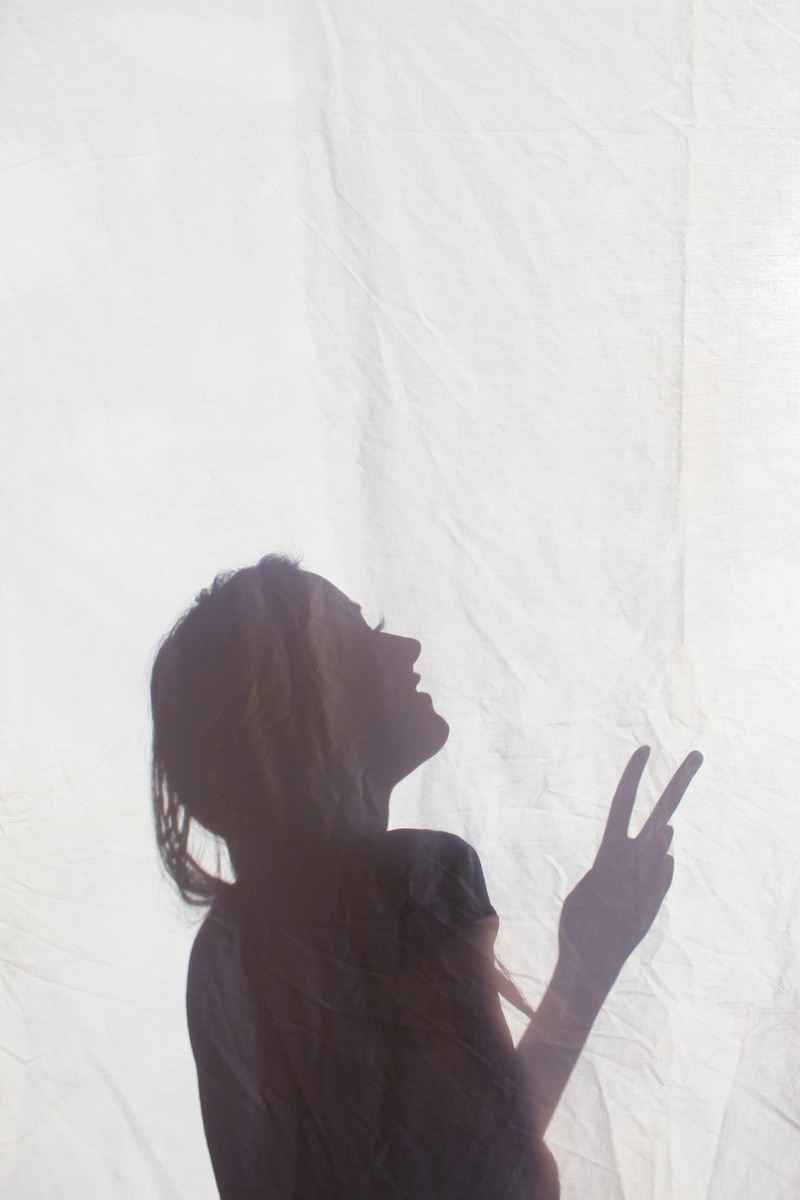 leisure activity, pacifist, spirit, indoors, 4K, woman, no war, side view, peace, real people, women, sign, day, gesturing, one person, hippy, shadow