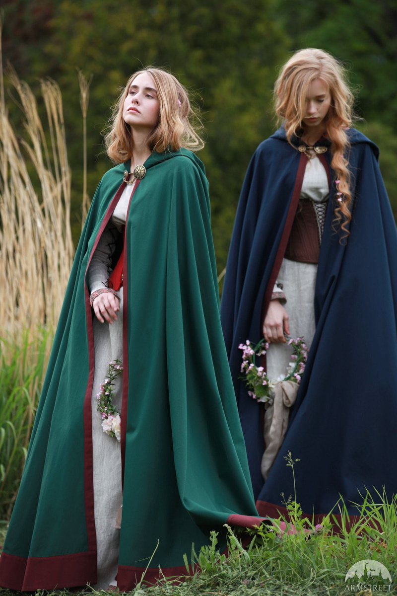 flower in hair, two people, grass, cloaks, corset, emotion, hairstyle, dress, outdoors, portrait, beautiful woman, clothing, portrait display, long hair