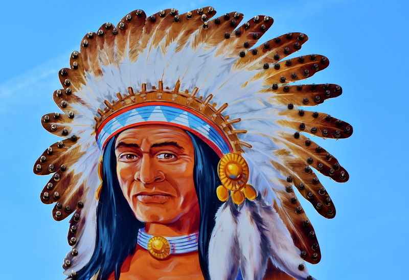 traditional clothing, arts culture and entertainment, clothing, blue, human representation, decoration, sky, male, portrait, metal sign, headwear, art and craft