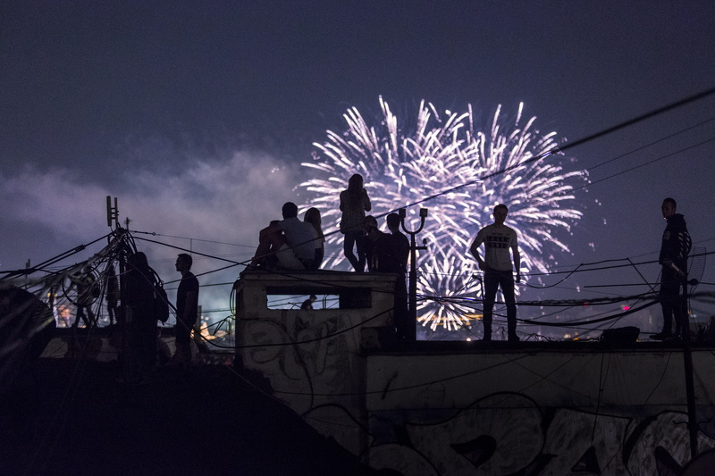 outdoors, lighting Equipment, silhouette, 2K, glow, fireworks, weekend, party, top, watching, light, city, night lights, firework, cityscape, contrast