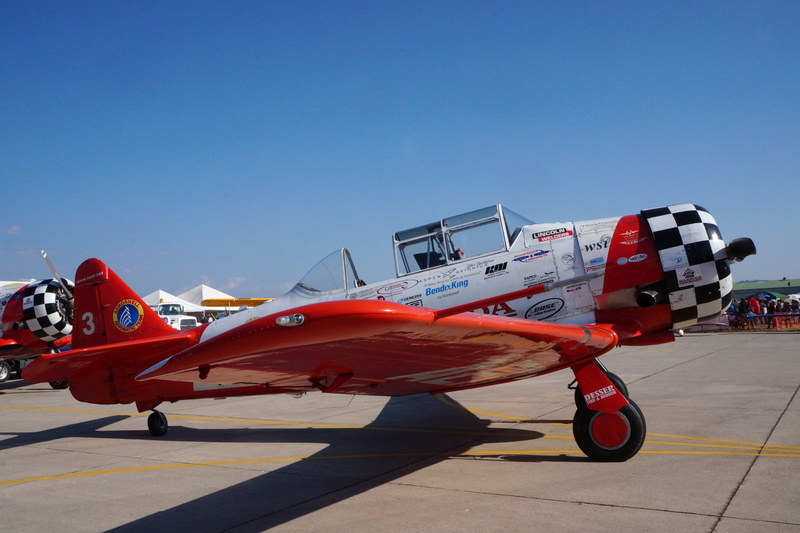 wheel, sunny, Plane, clear sky, red, propeller, 5K, pilot, blue, sunlight, clouds, outdoors, air show, small plane, air vehicle, military, on the move