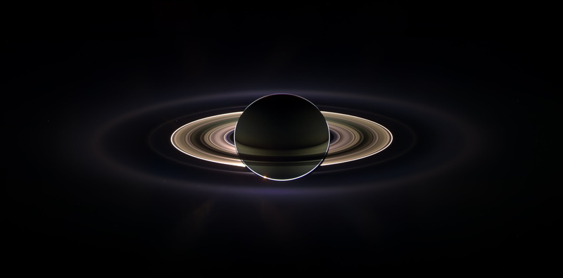 single object, black color, cosmos, colored background, shape, sun, concentric, dark, copy space, directly above, spotlight, studio shot, planet, indoors