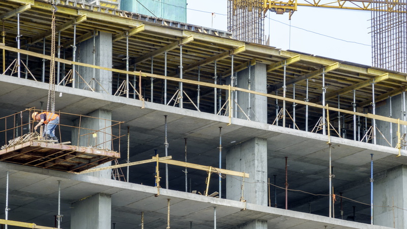 built structure, building, technology, concrete, low angle view, day, men, large, real people, construction, building exterior, incomplete, people, overlapping