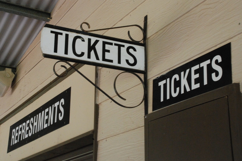 no people, information sign, outdoors, pay, low angle view, symbol, building exterior, direction, text, wall - building feature, hospital, information