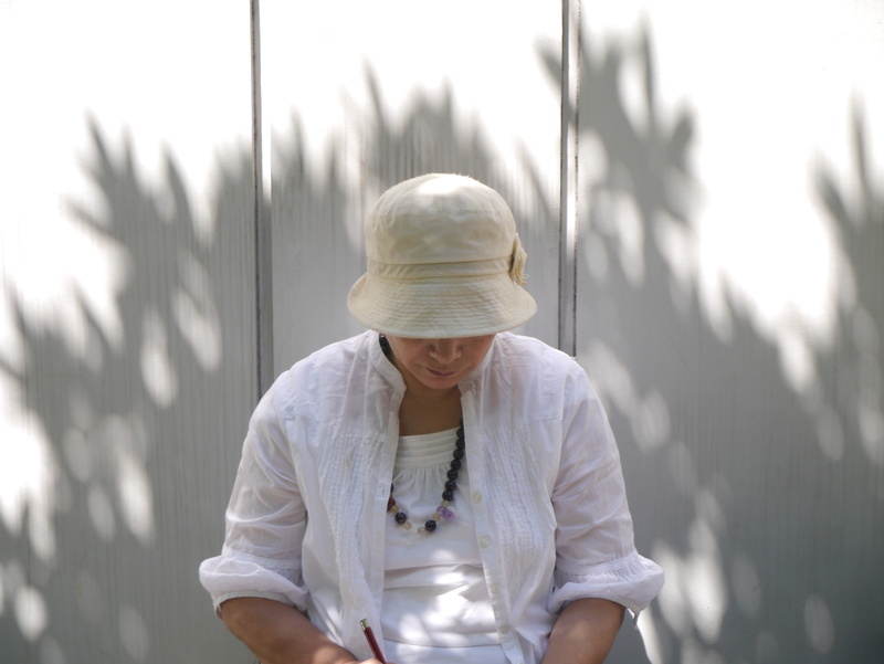 wall, scribe, hairstyle, japan, casual clothing, shadow, lifestyles, young adult, smiling, memo, waist up, shade, standing, hat, women, adult, clothing