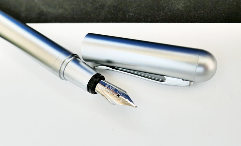 studio shot, silver colored, nib, document, no people, office supply, fountain pen, paper, office, black, writing utensil, writing implement, pen, business