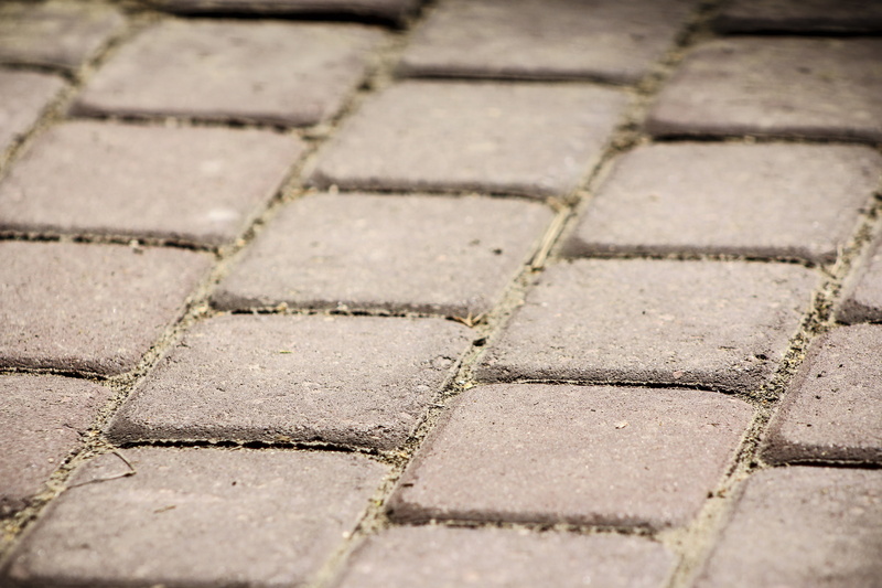 selective focus, day, city, stone material, backgrounds, pattern, way, concrete, go, in a row, cobblestone, dice mosaic, walkway, outdoors, geometric shape