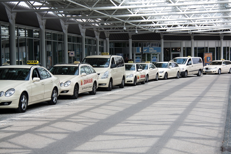 side by side, urban Scene, no people, taxi, parking lot, taxi rank, line, mode of transportation, sunlight, transport, airport, white, indoors, consumerism