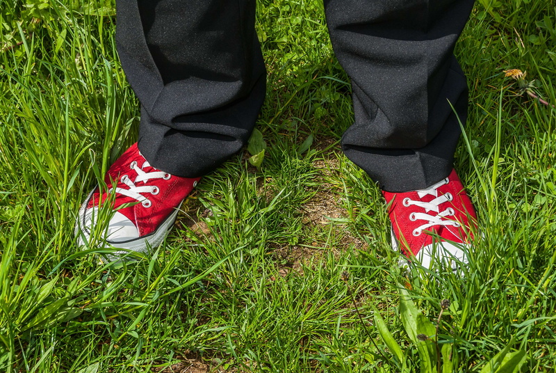 sock, leisure activity, shoe, real people, low section, white, white ribbon, pants, sneaker, field, day, red, cool, shoelace, chucks, green, grass, white ribbons