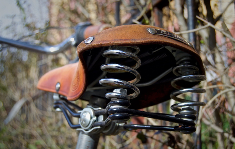 tanned, leather saddle, retracted, close-up, land vehicle, land, outdoors, bicycle saddle, seat, bicycle, no people, manufactory, hand labor, close, used