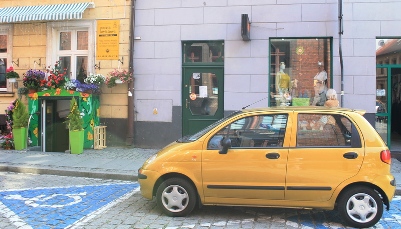 motor vehicle, poland, road, building, incidental people, window, yellow, land vehicle, 2K, public transportation, building exterior, outdoors, city, glass - material