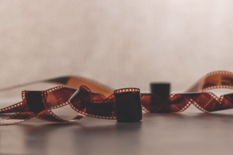 camera film, focus on foreground, surface, two objects, ornate, white, photography themes, studio shot, shadow, glasses, film, copy space, photo, filmstrip